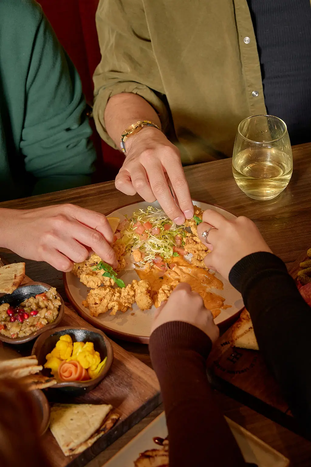 Group dining sharing appetizers at HotHouse Restaurant downtown Toronto