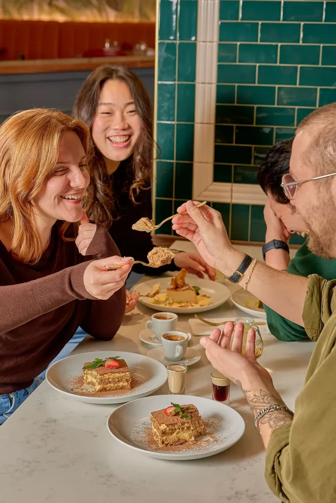 Friends gather around enjoying delicious Mediterranean food at HotHouse Restaurant in Toronto